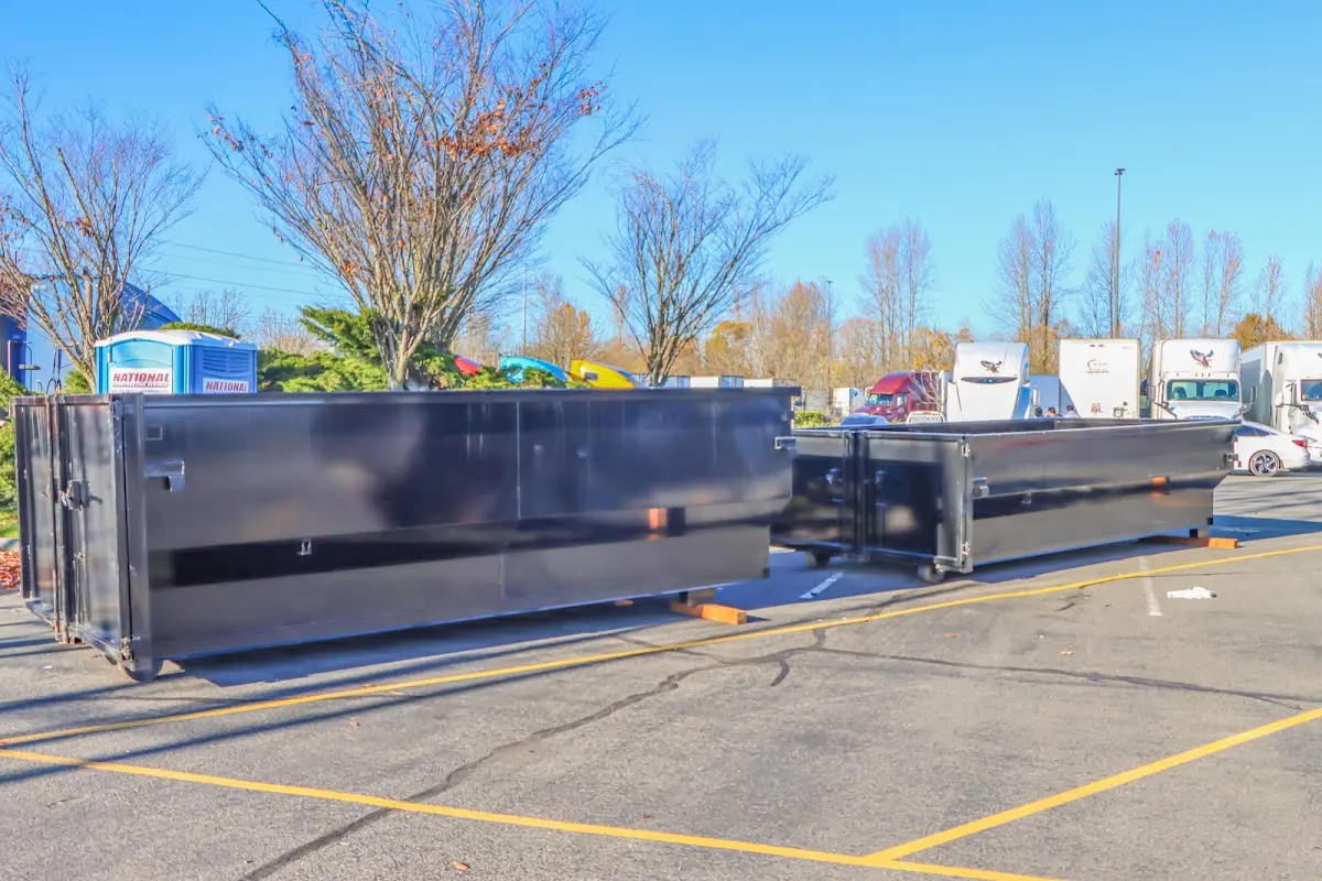 Professional dumpster rental service with roll-off container on residential driveway in Hickory